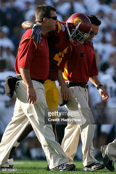 Joe McKnight of the USC Trojans is helped off the field by medical staff during the 95th Rose Bowl Game presented by Citi against the Penn State...