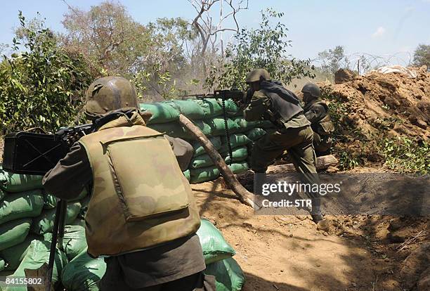 In this picture taken September 22 Sri Lankan government troops fire in the forward defence line in the village of Karambukulam on the outskirts of...