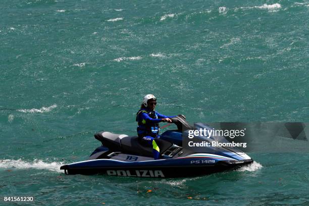 An Italian police officer patrols Lake Como on a jet-ski during the Ambrosetti Forum in Cernobbio, Italy, on Friday, Sept. 1, 2017. Policy makers and...