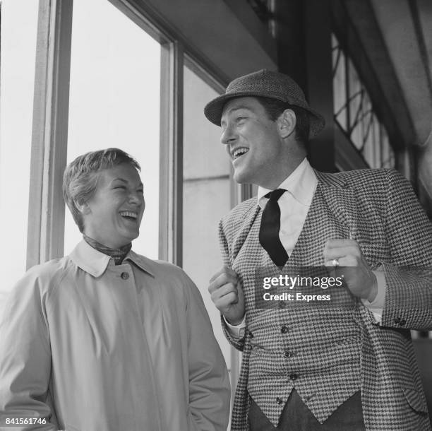 American actor Dick Van Dyke laughs with his wife Margie Willett upon their arrival in Southampton, UK, 15th April 1964.