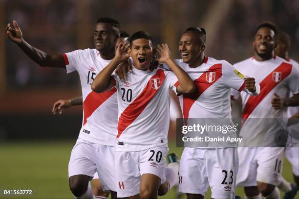 Edison Flores celebrates with Pedro Aquino and Christian Ramos after scoring the first goal of his team during a match between Peru and Bolivia as...