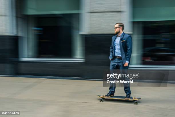 businessman on skateboard - longboard surfing stock pictures, royalty-free photos & images