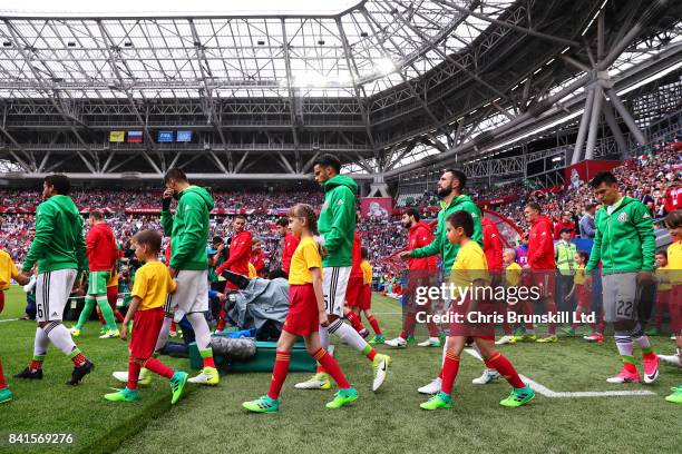 The two teams walk out ahead of the FIFA Confederations Cup Russia 2017 Group A match between Mexico and Russia at Kazan Arena on June 24, 2017 in...