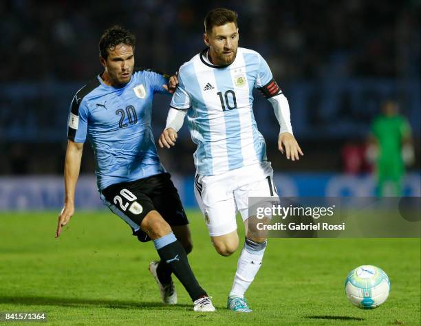 Lionel Messi of Argentina fights for the ball with Alvaro Gonzalez of Uruguay during a match between Uruguay and Argentina as part of FIFA 2018 World...