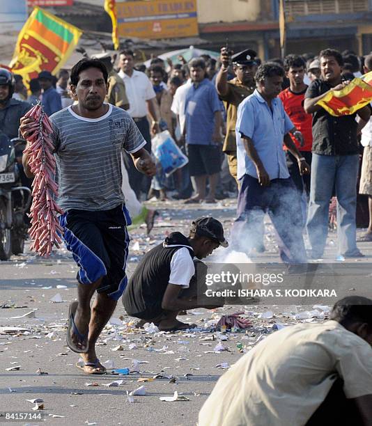 Sri Lankan people wave the national flag and light fire crackers in the streets of Colombo on January 2 to celebrate the military capturing the...