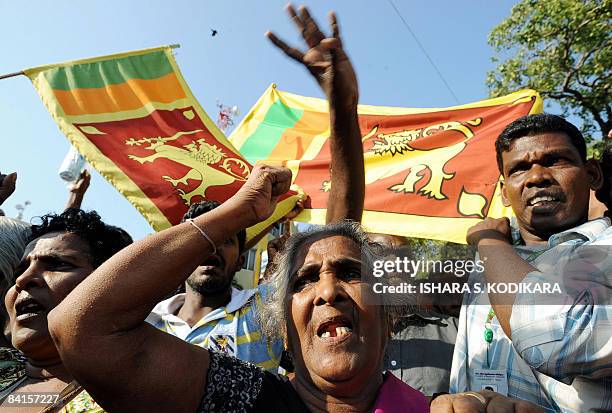 Sri Lankan wave the national flag in Colombo on January 2 to celebrate the military capturing the northern town of Kilinochchi on Friday. Ground...