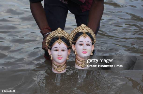 Devotees during the seventh day immersion of Ganesha idols at Rayladevi artificial Lake Thane, on August 31, 2017 in Mumbai, India. Several devotees,...