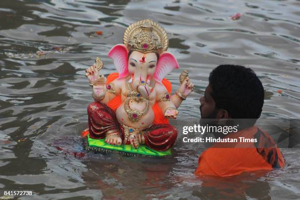 Devotees during the seventh day immersion of Ganesha idols at Rayladevi artificial Lake Thane, on August 31, 2017 in Mumbai, India. Several devotees,...