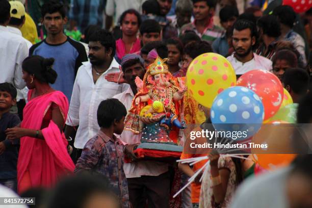 Devotees during the seventh day immersion of Ganesha idols at Rayladevi artificial Lake Thane, on August 31, 2017 in Mumbai, India. Several devotees,...