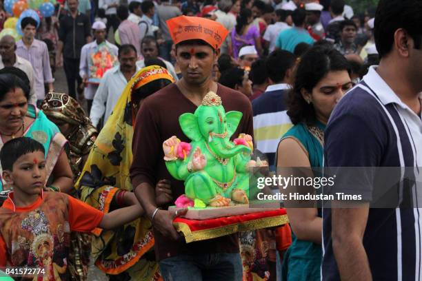 Devotees during the seventh day immersion of Ganesha idols at Rayladevi artificial Lake Thane, on August 31, 2017 in Mumbai, India. Several devotees,...