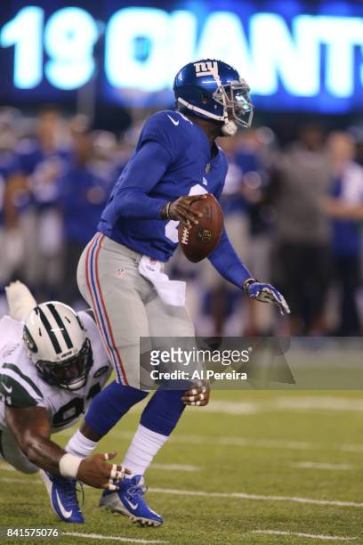 Defensive Lineman Sheldon Richardson of the New York Jets sacks Quarterback Josh Johnson of the New York Giants during a preseason game on August 26,...
