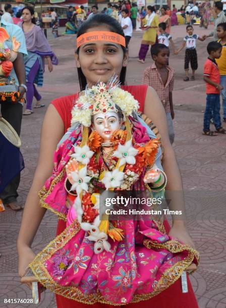 Girl carrying Gauri idol for immersion on the 7th day of Ganesh festival in Kalyan, on August 31, 2017 in Mumbai, India. Several devotees, who...