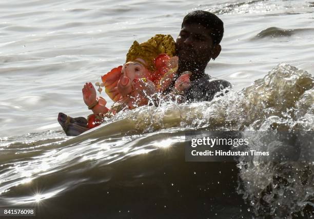 Devotees during the seventh day immersion of Ganesha idols at Dadar Chowpatty, on August 31, 2017 in Mumbai, India. Several devotees, who brought the...