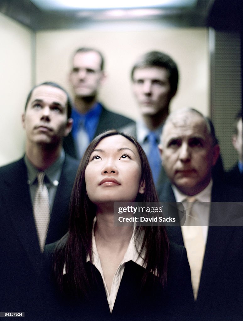 Business group in elevator