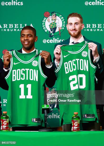 Kyrie Irving and Gordon Hayward hold up their jesrseys as they are introduced as the newest members of the Boston Celtics at TD Gardens on September...