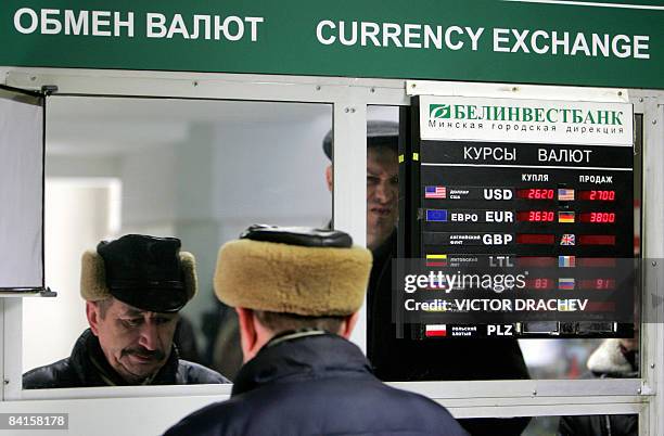 Belarussian man stands at a currency exchange point in Minsk on January 2, 2009. Belarus on Friday devalued its ruble by more than a fifth against...