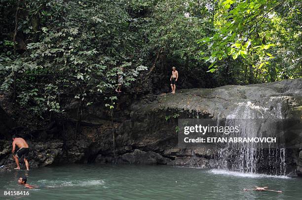 Tourists visit the Seven Altars' freshwater falls and pools, about 5 km nortwest of Livingston, along the shore of Bahia de Amatique in Guatemala, on...