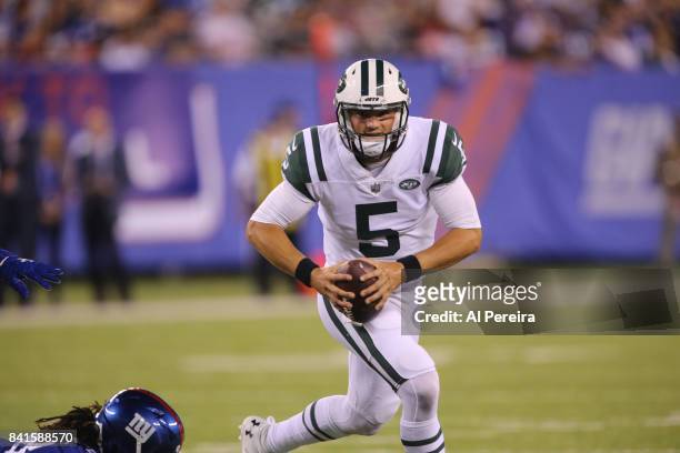 Quarterback Christian Hackenberg of the New York Jets rolls out against the New York Giants during a preseason game on August 26, 2017 at MetLife...