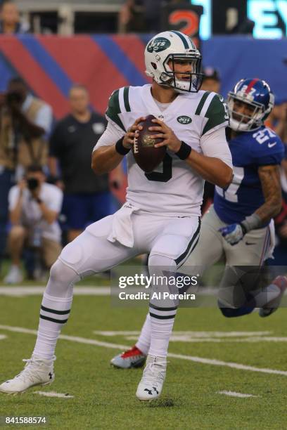 Quarterback Christian Hackenberg of the New York Jets passes the ball against the New York Giants during a preseason game on August 26, 2017 at...
