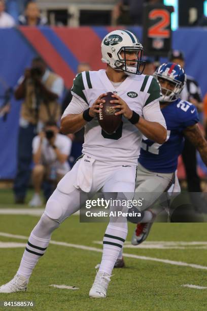 Quarterback Christian Hackenberg of the New York Jets passes the ball against the New York Giants during a preseason game on August 26, 2017 at...