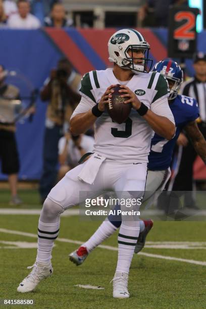 Quarterback Christian Hackenberg of the New York Jets passes the ball against the New York Giants during a preseason game on August 26, 2017 at...