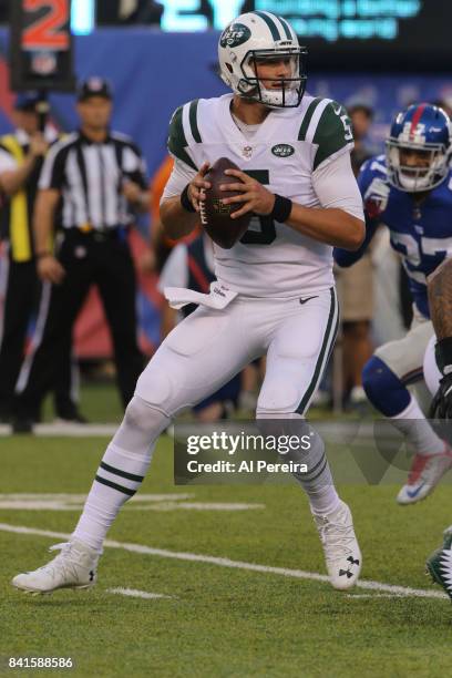 Quarterback Christian Hackenberg of the New York Jets passes the ball against the New York Giants during a preseason game on August 26, 2017 at...