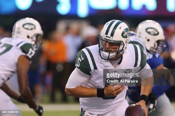 Quarterback Christian Hackenberg of the New York Jets rolls out against the New York Giants during a preseason game on August 26, 2017 at MetLife...