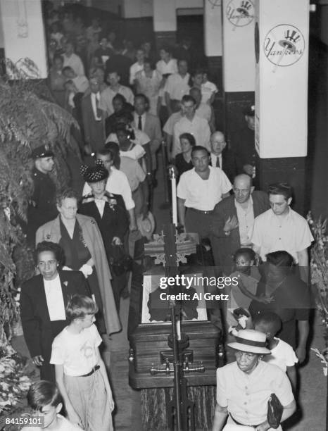 As the body of American baseball player Babe Ruth lies in state in the rotunda of Yankee Stadium, fans numbering in the tens of thousands file past...