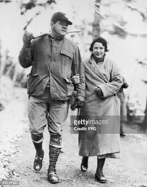 American baseball player Babe Ruth , a gun over his shoulder, walks with his wife Claire Ruth as they hunt quail, Maine, November 29, 1933.