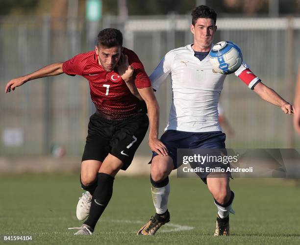 Alessandro Bastoni of Italy competes for the ball with Karakas Ilker of Turkey during the U19 international friendly match between Italy U19 and...