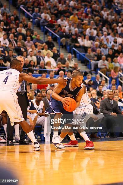 Georgetown guard Chris Wright breaks the defense of Connecticut forward Jeff Adrien and Kemba Walker. NCAA Basketball: Georgetown at UConn Monday -...