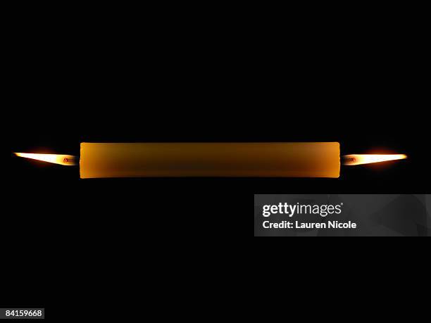 candle burning at both ends on black background - burning the candle at both ends stock pictures, royalty-free photos & images