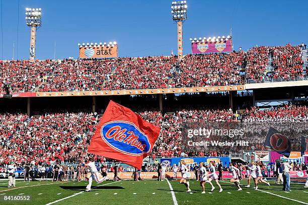 Cheerleaders of the Ole Miss Rebels run onto the field before the AT&T Cotton Bowl against the Texas Tech Red Raiders on January 2, 2009 at the...