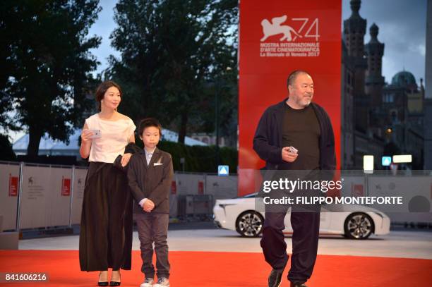 Chinese artist and producer Ai Weiwei arrives with his wife Lu Qing and his son at the premiere of the movie "Human Flow" presented in competition at...