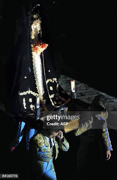 Spanish bullfigther Antonio Ferrera and Colombian Ricardo Rivera carry the image of the Virgin of La Macarena during the celebration of its day prior...