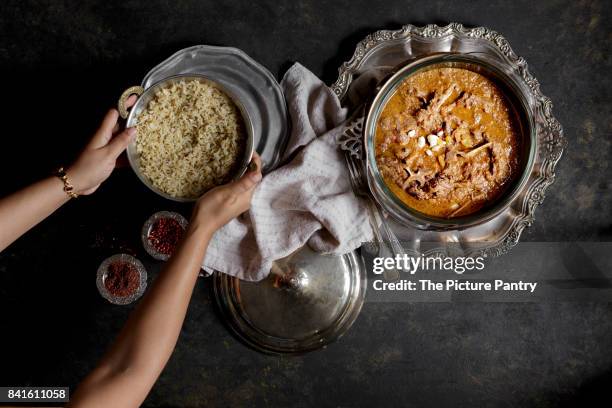 an indian meat curry with rice, served in silver bowls - indian food bowls stock-fotos und bilder