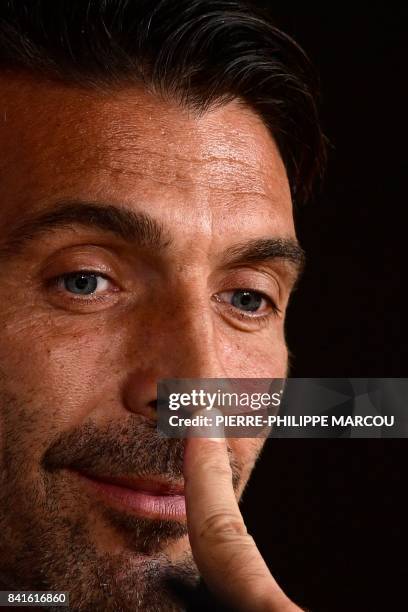 Italy's goalkeeper Gianluigi Buffon touches his nose during a press conference at the Santiago Bernabeu stadium in Madrid on September 1 on the eve...