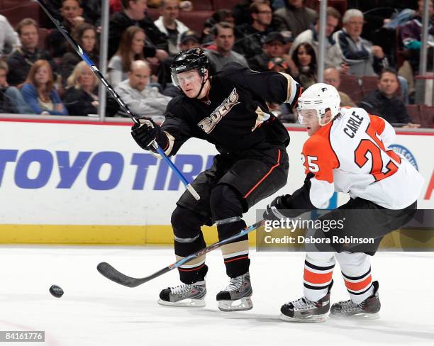 Matt Carle of the Philadelphia Flyers reaches in for the puck against Samuel Pahlsson of the Anaheim Ducks during the game on January 2, 2009 at...