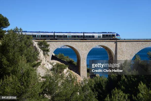 train crossing the niolon viaduct near marseille - train vehicle stock pictures, royalty-free photos & images