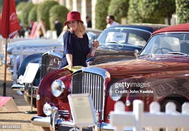 An owner polishes her car on display at the Concours de Elegance at Hampton Court Palace on September 1, 2017 in London, England. The show brings...