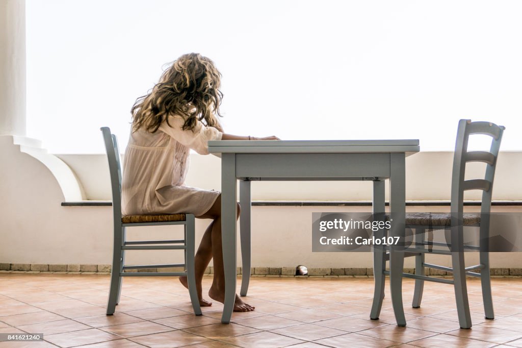 Premium Photo  Pensive woman sitting at table while thinking