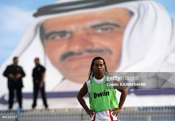 Milan's Brazilian player Ronaldinho attends a training session with his team as security personnel stand guard in Dubai January 3, 2009. Italian...