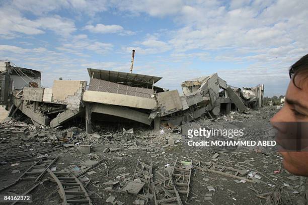 Palestinian youth inspects the rubble following an Israeli air strike targeting the American International school of Gaza in Beit Lahia on January 3,...