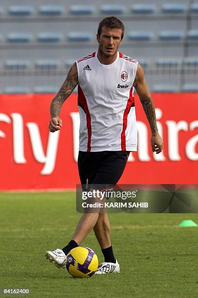 England's midfielder David Beckham, on loan to Italy's AC Milan from US Major League Soccer club Los Angeles Galaxy, attends a training session with...