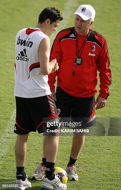 Milan Brazilian player Kaka speaks with his coach Carlo Ancelotti during a training session with his team in Dubai January 3, 2009. Italian football...