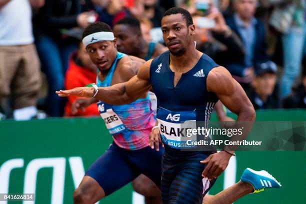 Jamaica's sprinter Yohan Blake celebrates as he crosses the finish line to win, ahead of US ichael Rodgers ,the men's 100m race during the AG...