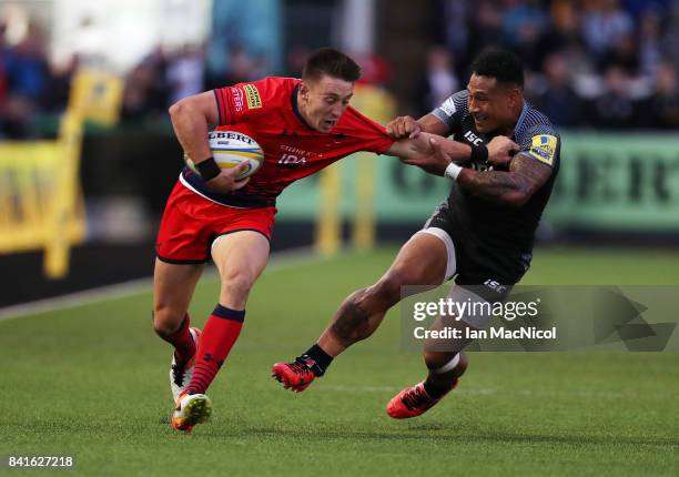 Josh Adams of Worcester Warriors vies with Sonatane Takulua of Newcastle Falcons during the Aviva Premiership match between Newcastle Falcons and...