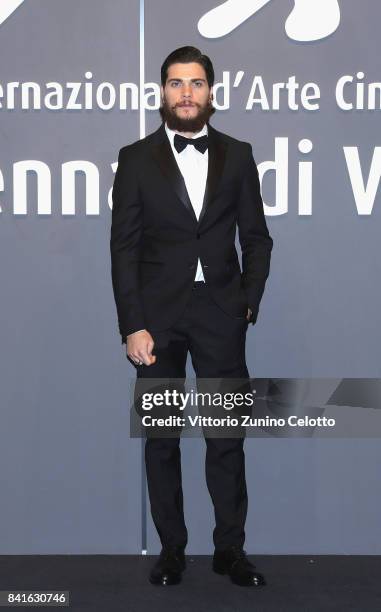 Alessio Lapice walks the red carpet ahead of the 'Nato A Casal Di Principe' screening during the 74th Venice Film Festival at Sala Giardino on...