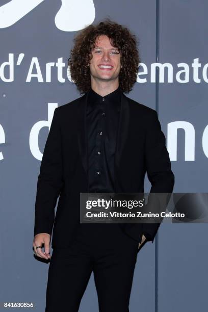 Francesco Pellegrino walks the red carpet ahead of the 'Nato A Casal Di Principe' screening during the 74th Venice Film Festival at Sala Giardino on...