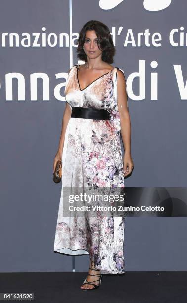 Donatella Finocchiaro walks the red carpet ahead of the 'Nato A Casal Di Principe' screening during the 74th Venice Film Festival at Sala Giardino on...